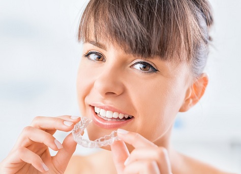 Woman Putting in Clear Aligners