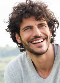 A man with curly and a nice smile