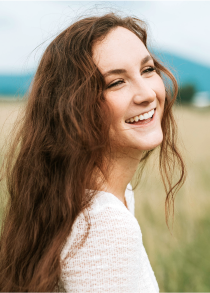 Woman in a field smiling