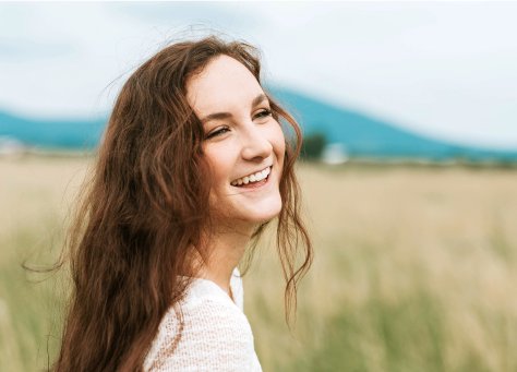 Woman in a field smiling