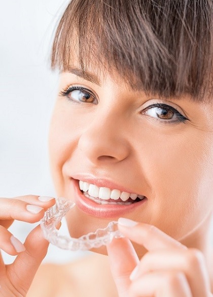 Woman Putting in Clear Aligners