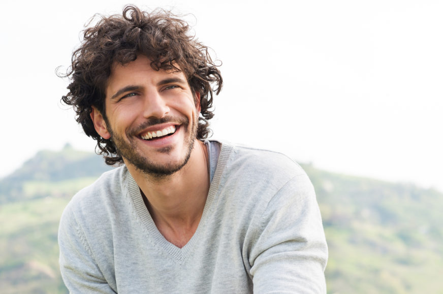 A man with curly and a nice smile