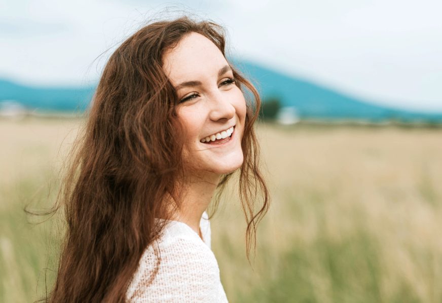 Woman in a field smiling